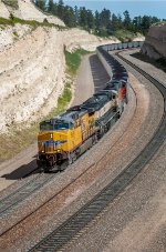 UP 5619 and BNSF 9446 and 9480 power the eastbound Jefferies Energy coal train snaking its way over the summit of Crawford Hill